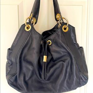 Michael Kors black handbag. In good condition, with minor wear from usage.